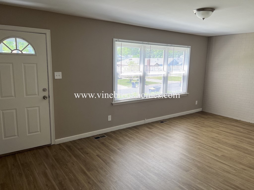 a bedroom with a door and a window