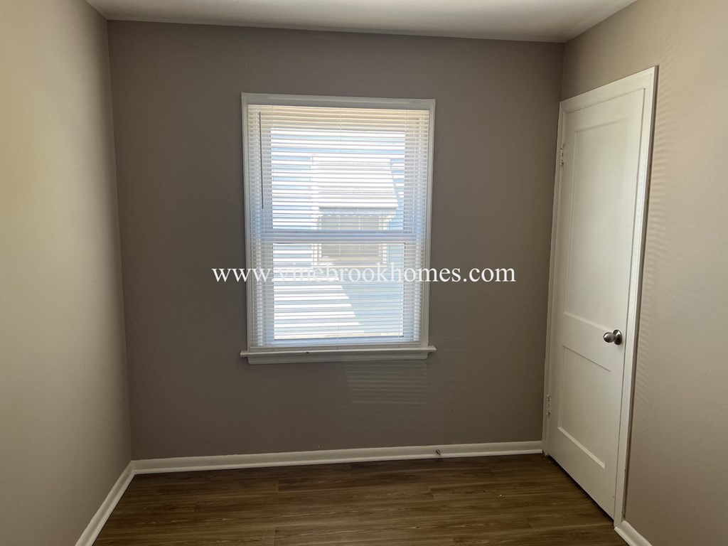 a small room with a window and a door