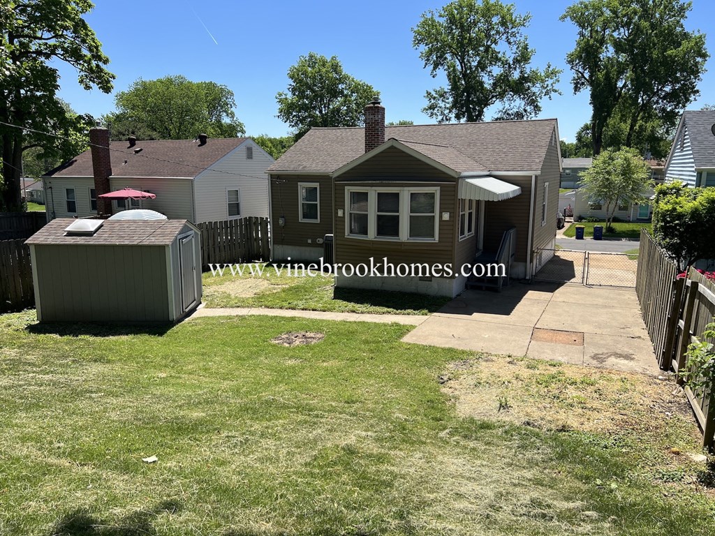 a backyard with a house and a hot tub