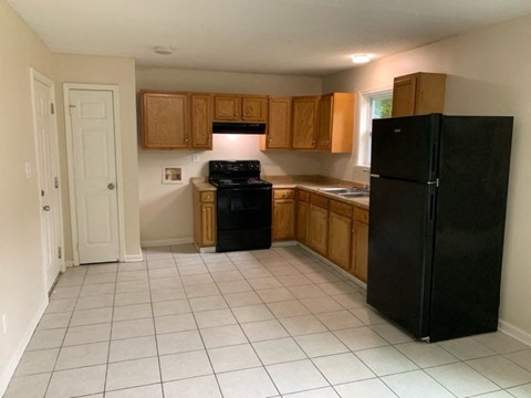 a kitchen with black appliances and wooden cabinets