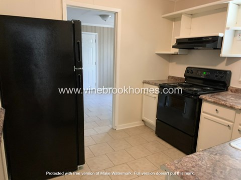 a kitchen with black appliances and a black refrigerator