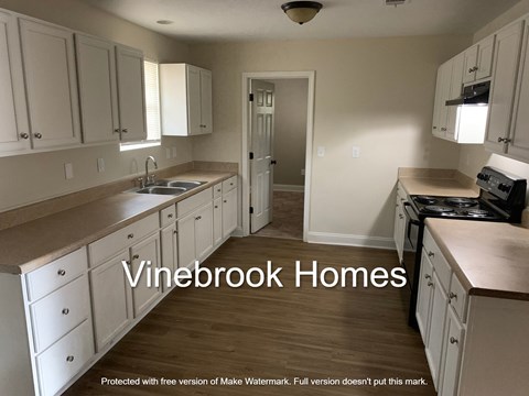 A kitchen with the words Vinebrook Homes overlaid on the image.