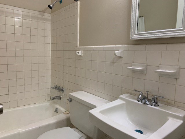 a white bathroom with a sink and a toilet