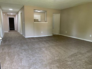 an empty living room and kitchen in a house