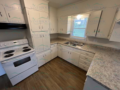 a kitchen remodel with white appliances and white cabinets