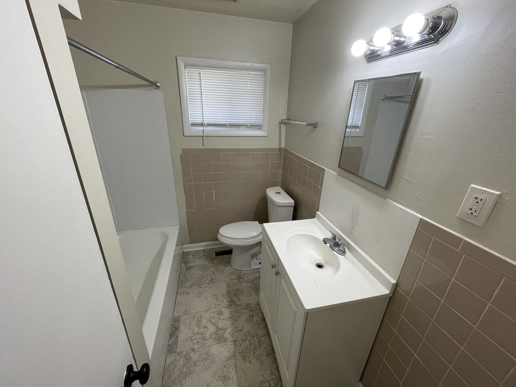 a bathroom with a sink toilet and a tub