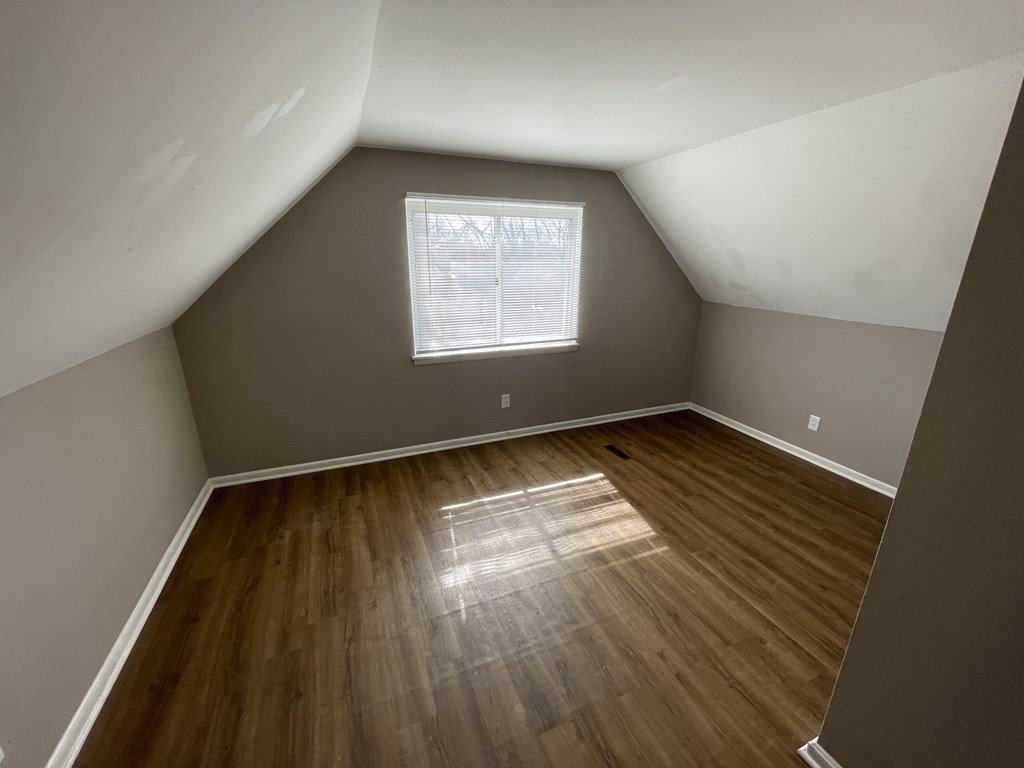 the interior of a home with wooden floors and a window