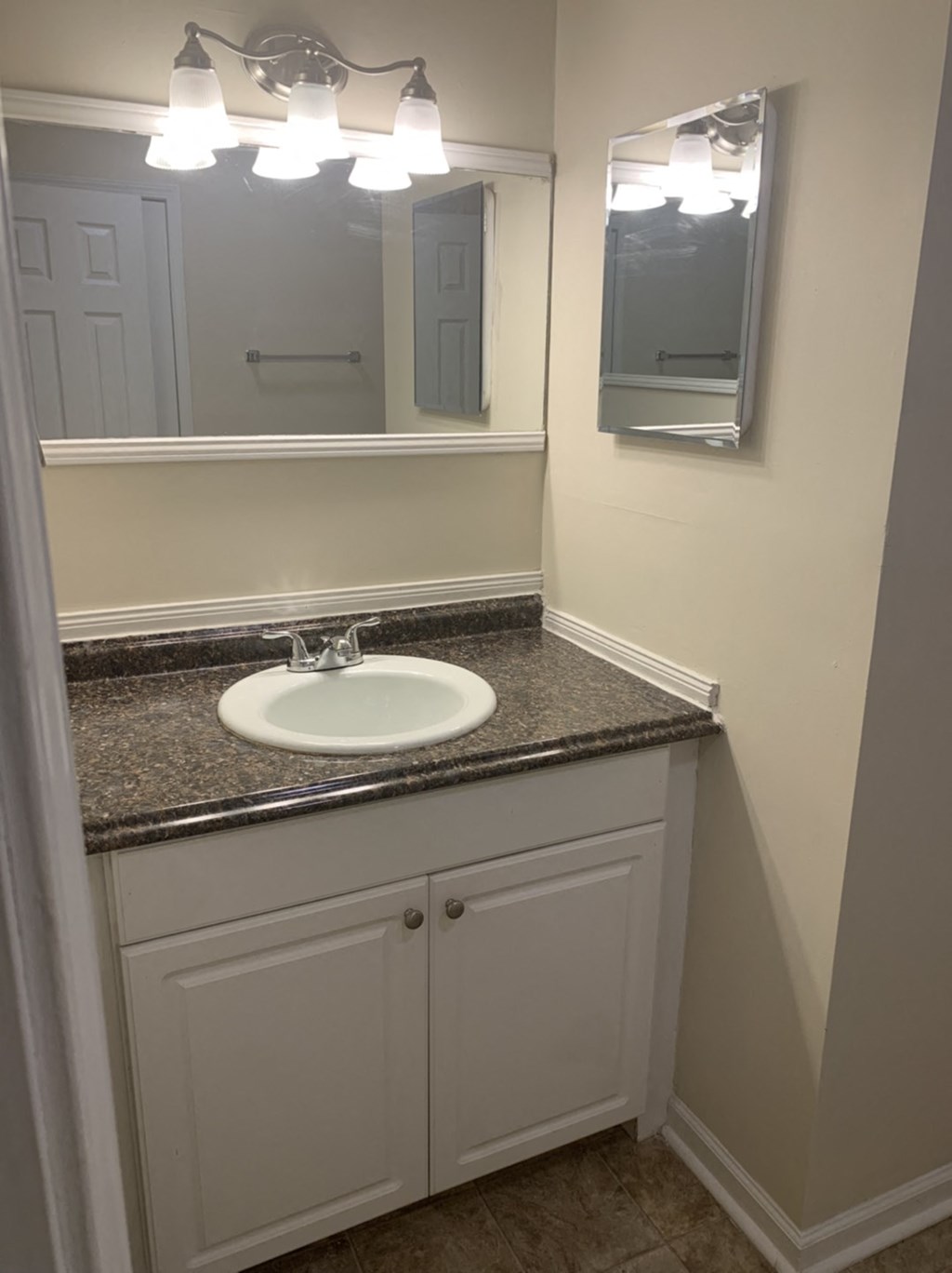 a small bathroom with a sink and a mirror