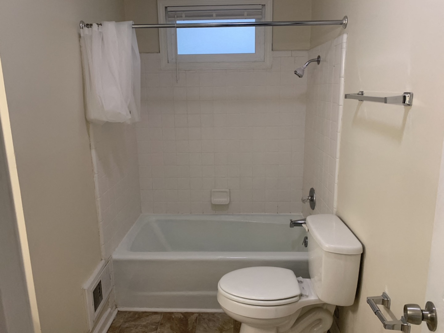 a small bathroom with a toilet and a bath tub