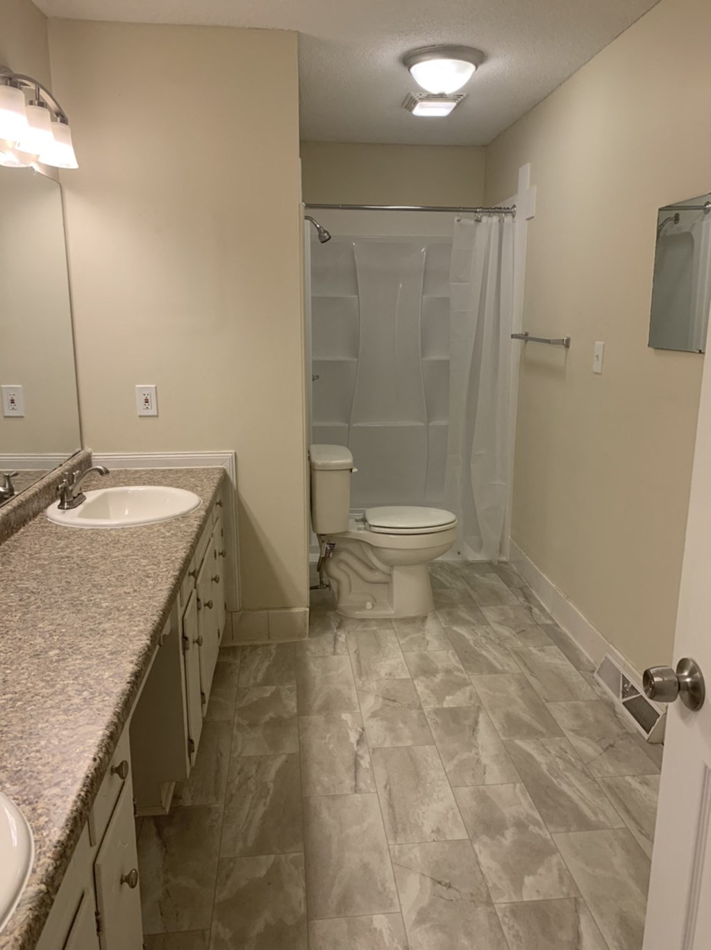 a bathroom with a toilet and a sink and a shower
