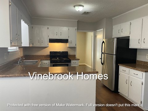 a view of a kitchen with white cabinets