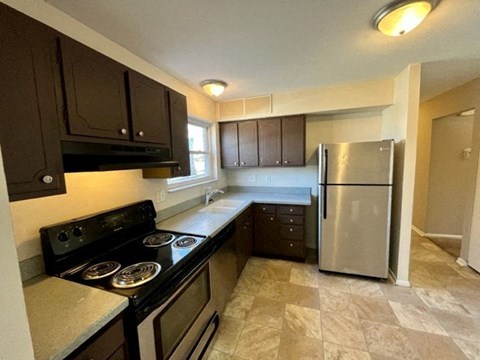 a kitchen with a stove and a refrigerator
