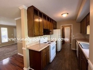 a large kitchen with a stove and a sink