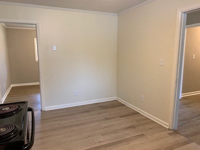 an empty living room with a hard wood floor