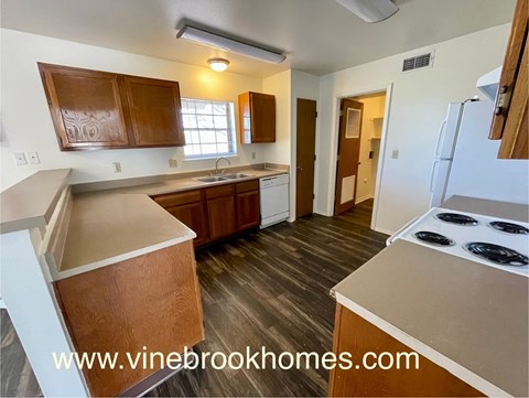 A kitchen with a stove top oven and a sink.