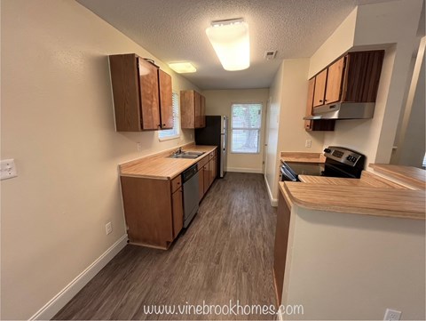 A kitchen with wooden cabinets and a countertop.