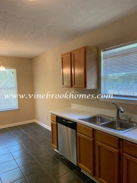 a kitchen with a sink and a dishwasher