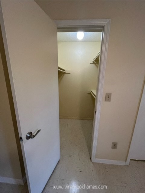 an empty closet in a room with a door open