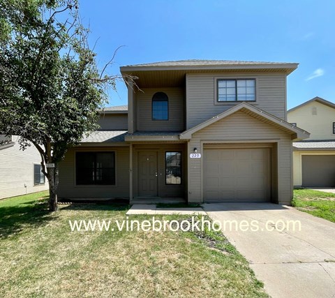 A two-story house with a garage is shown in the image.