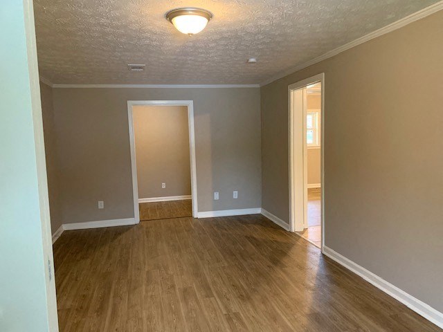 an empty living room with a hard wood floor