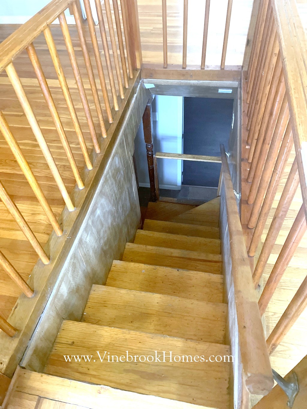 a set of wooden stairs leading up to a cellar