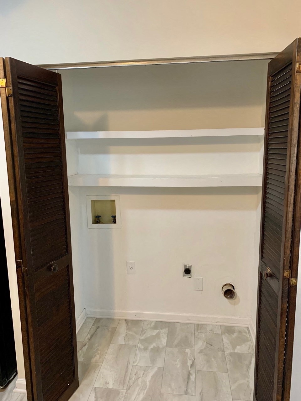 an empty room with white walls and wooden doors