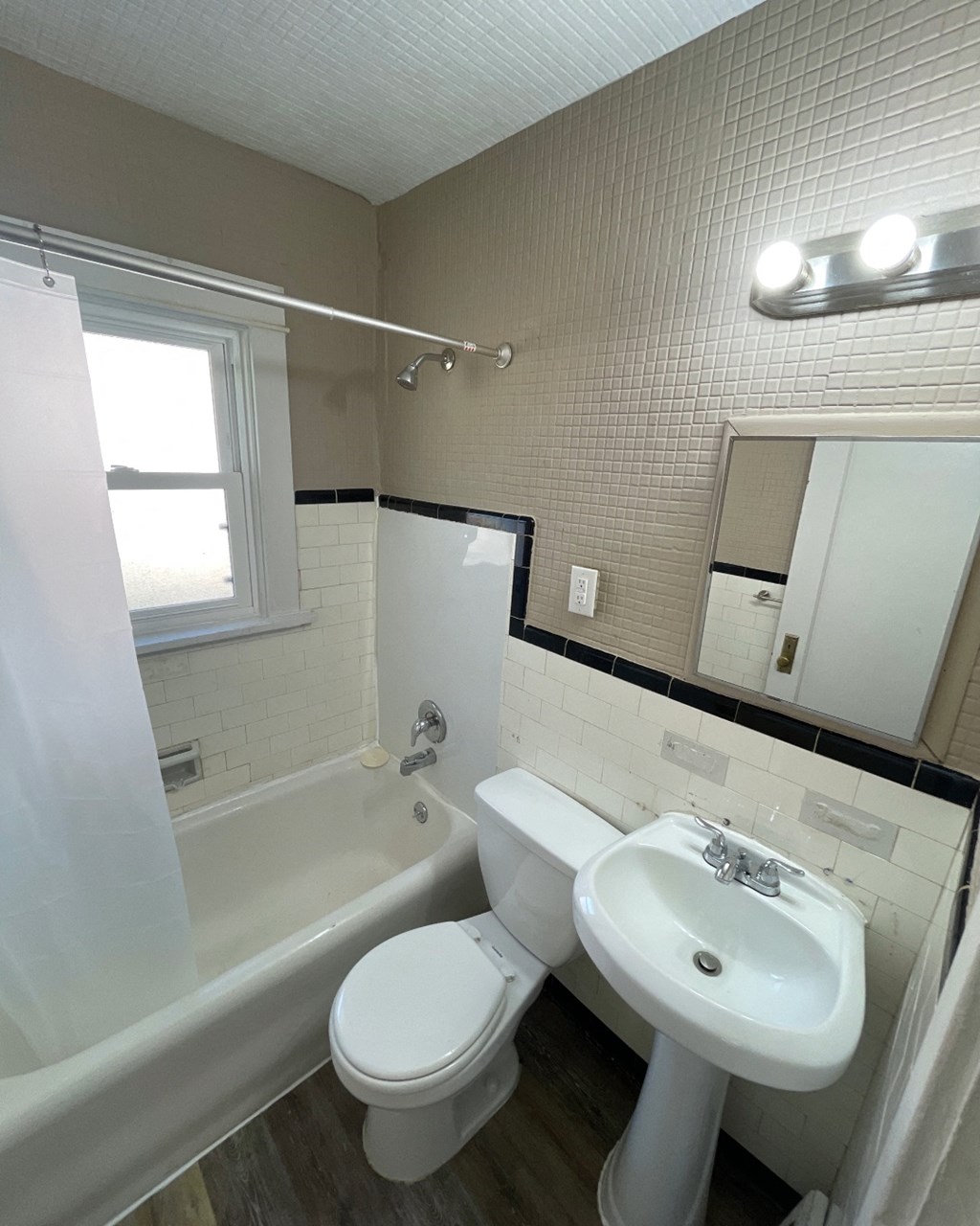 an image of a bathroom with a sink toilet and tub