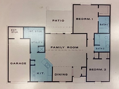 A floor plan of a house with a garage, two bedrooms, a family room, a utility room, a dining room, and a patio.