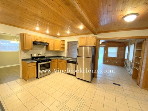 a kitchen with stainless steel appliances and wooden cabinets