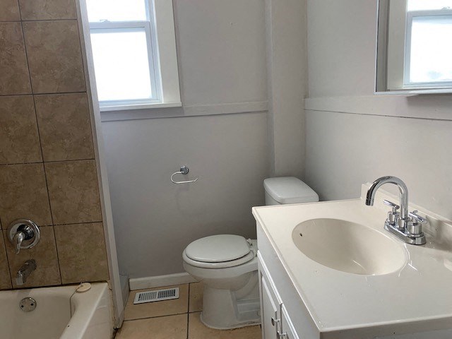 a bathroom with a toilet and a sink and a shower