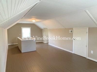 a large living room with hardwood floors and a table
