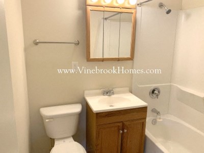 a bathroom with a toilet and a sink and a bath tub