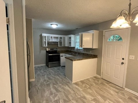 a kitchen with a counter top and a door