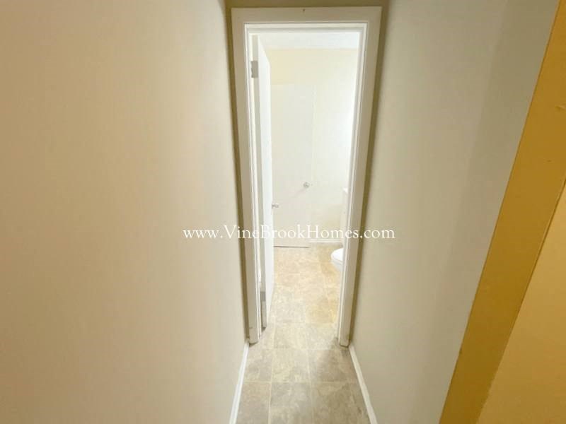 a hallway with a door to a closet      and a door