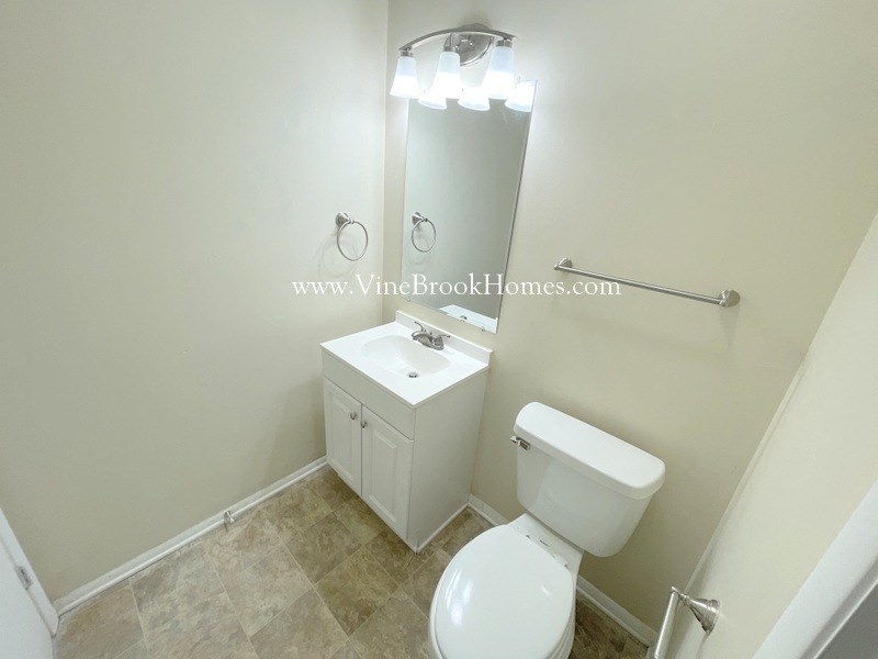 a bathroom with a toilet and a sink and a mirror