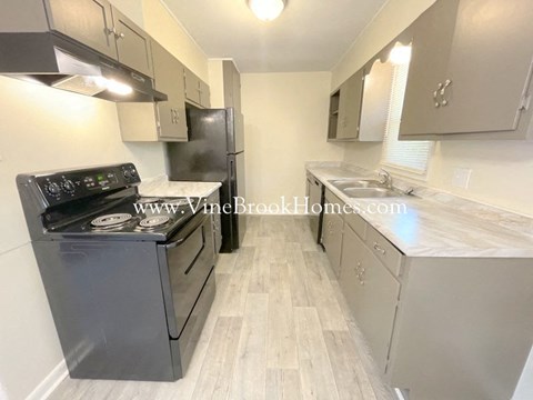 a kitchen with stainless steel appliances and white cabinets