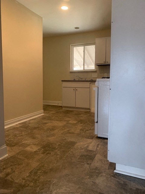 A kitchen area with a refrigerator and cabinets.