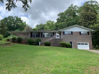 a brick house with a lawn in front of it