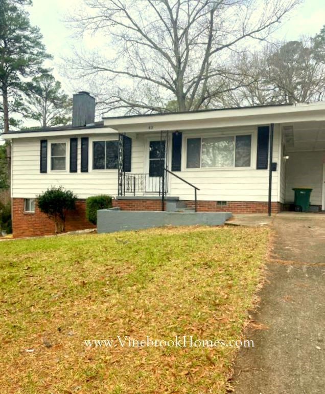 a white house with a front porch and a driveway