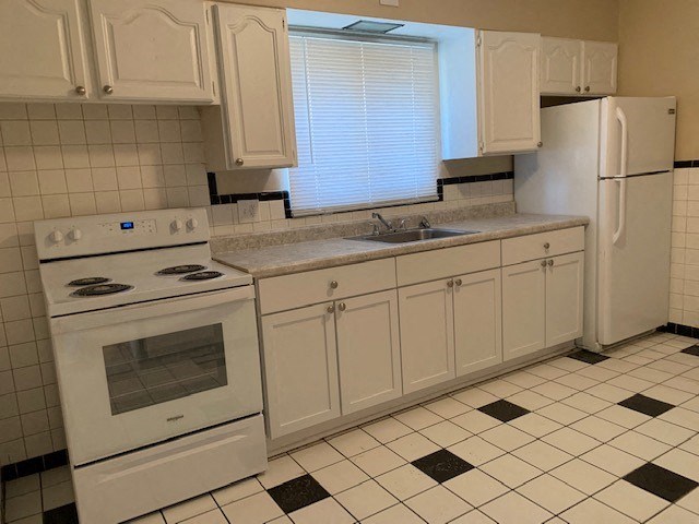 a kitchen with a stove refrigerator and sink