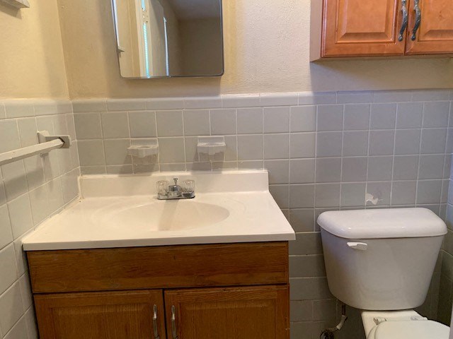 a bathroom with a white sink and a toilet