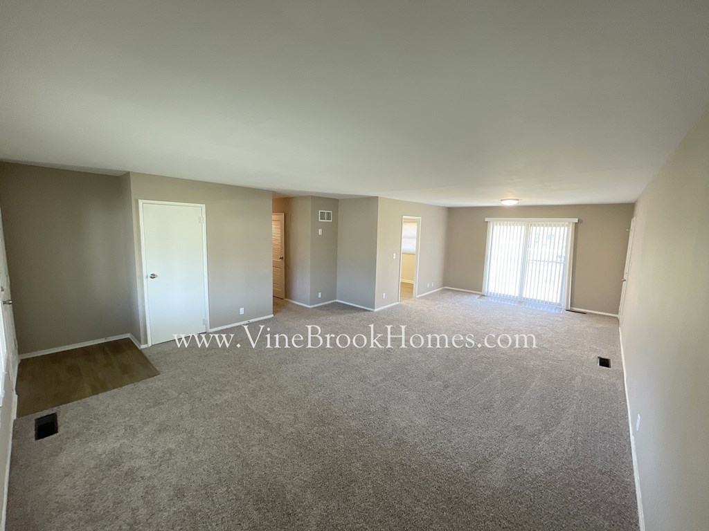 the living room and dining room of an apartment at the vine brook homes