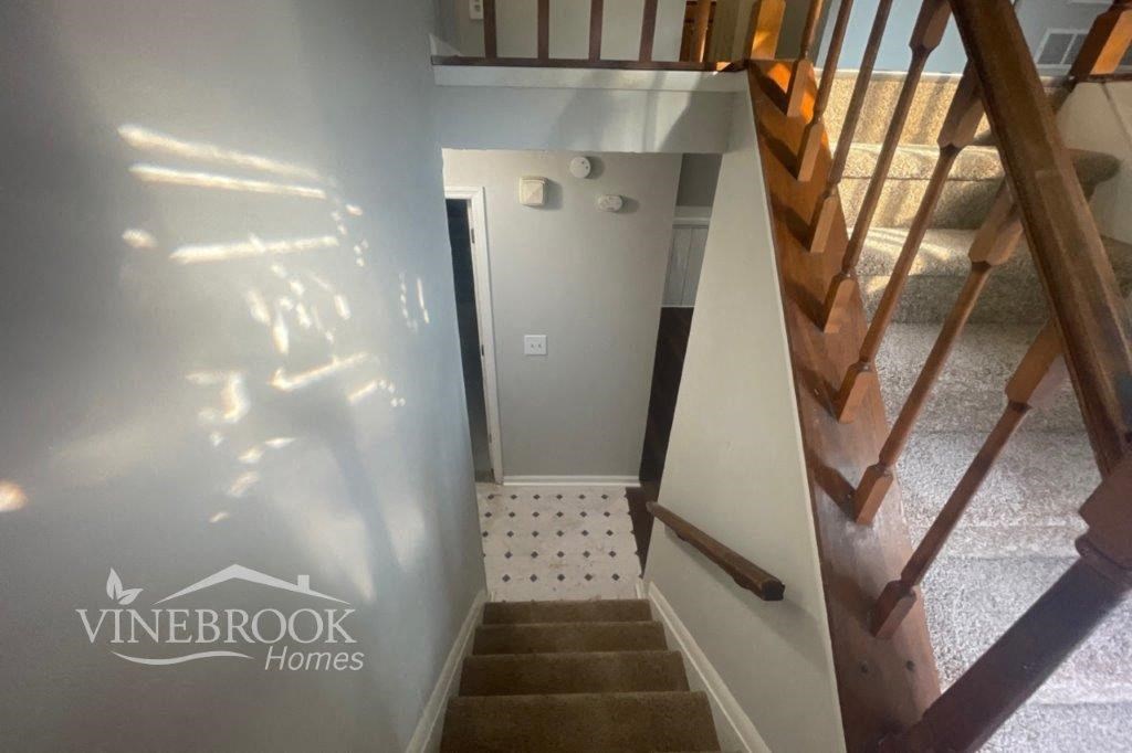 a stairwell in a house with stairs and a door