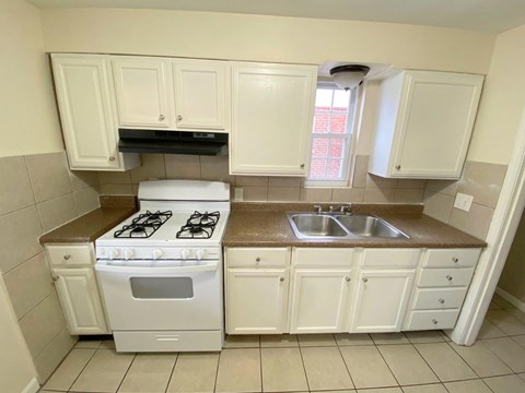 a kitchen with white appliances and white cabinets