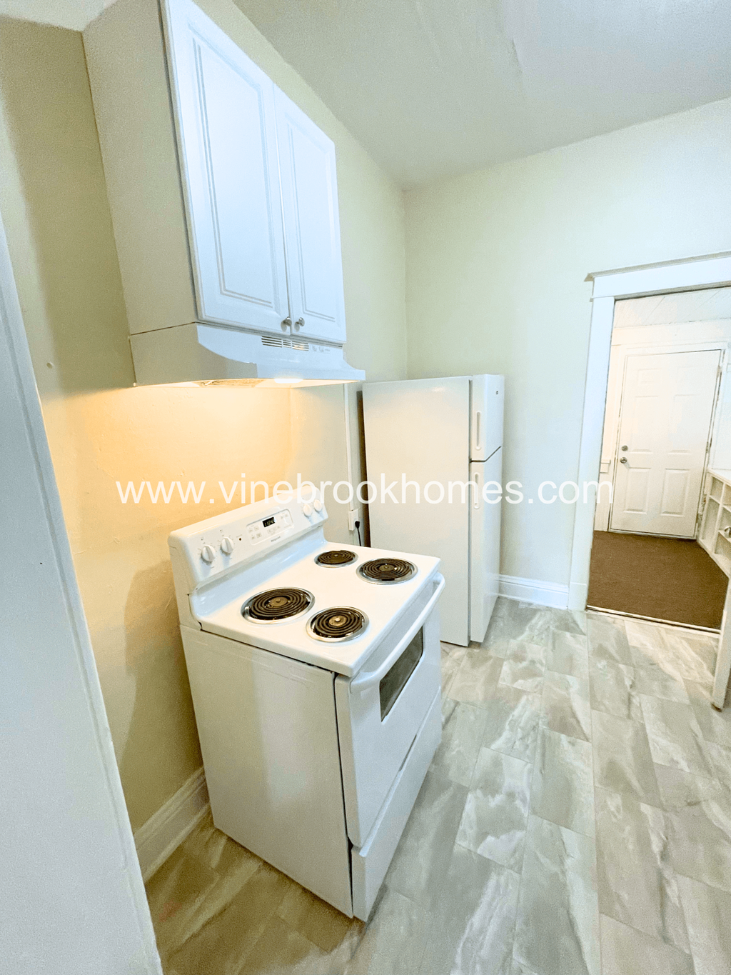 a kitchen with a white stove and a refrigerator
