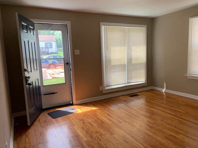 an empty room with a door and a window