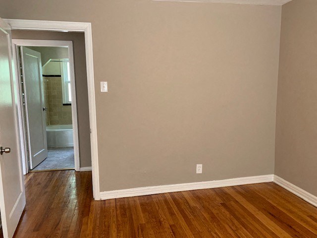 an empty room with a door to a bathroom