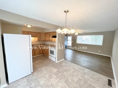 an open kitchen and dining room with a chandelier