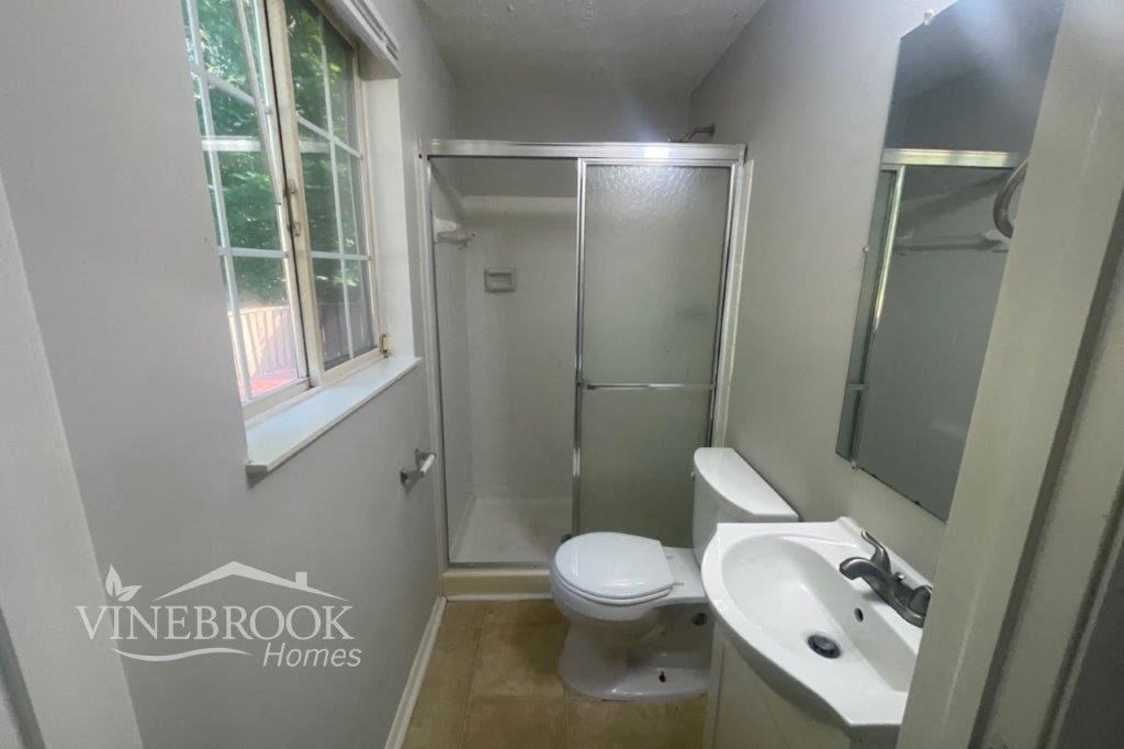a bathroom with a toilet sink and a shower