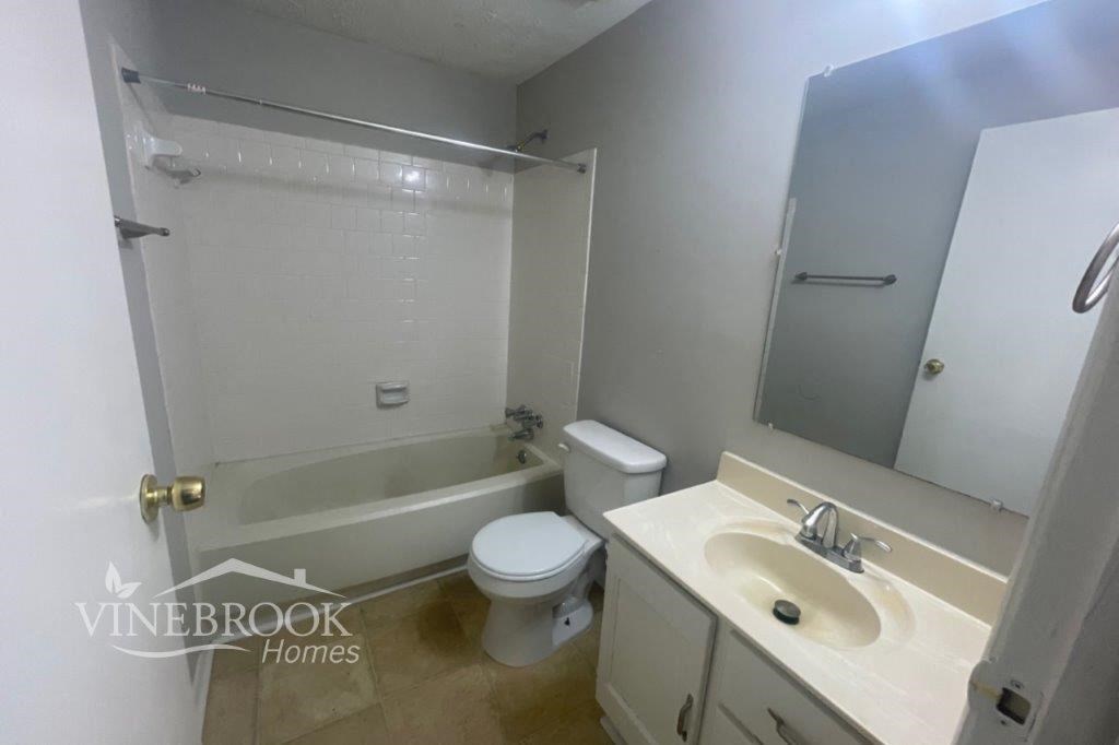 a bathroom with a sink toilet and a bath tub